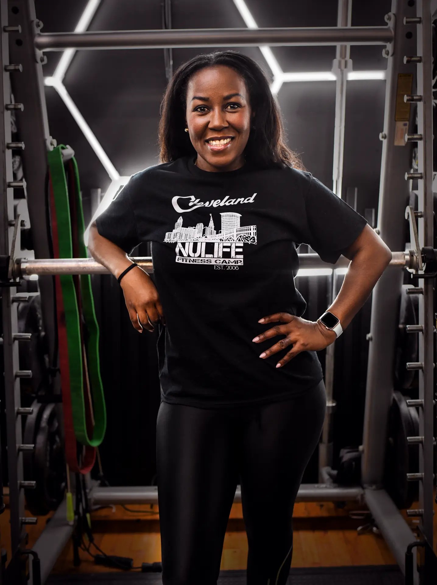 Meisha smiling in her NuLife shirt in the fitness studio