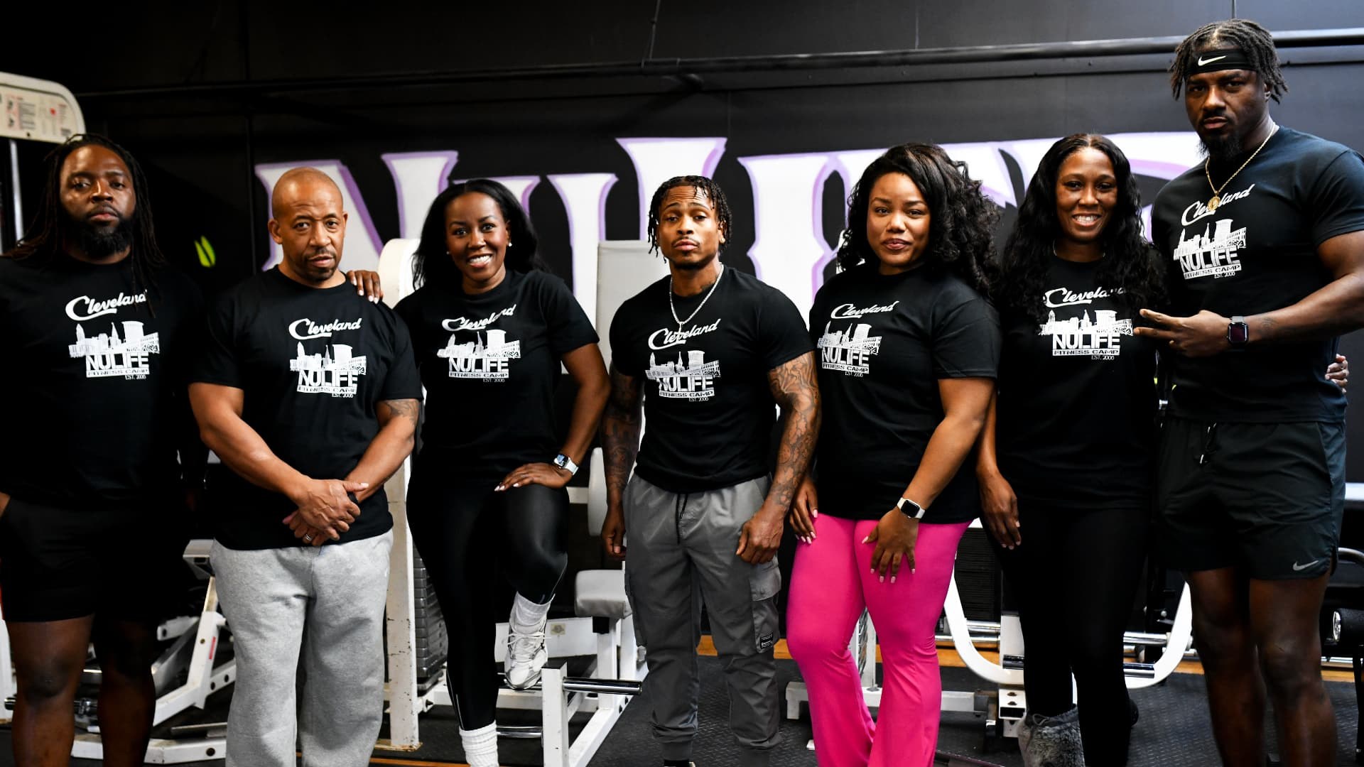 Seven NuLife trainers standing together for a group portrait in the studio